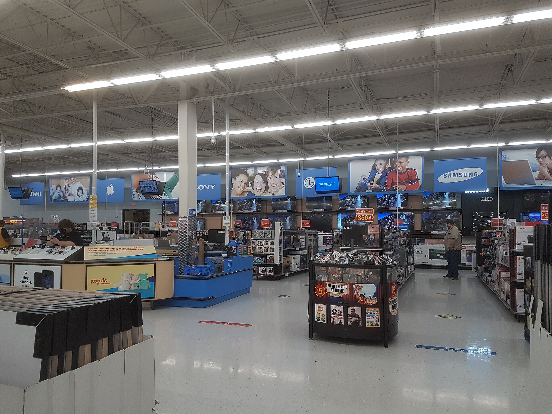 Electronics section inside a Walmart Canada store in Edmonton with TV wall and merchandise aisles